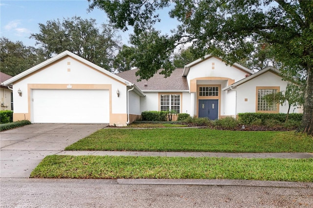 single story home with a garage and a front lawn