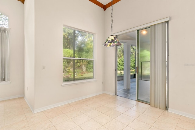 unfurnished dining area featuring plenty of natural light and light tile patterned floors