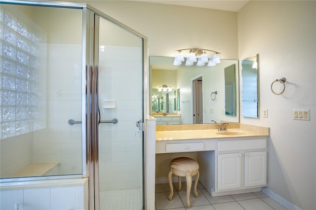 bathroom featuring vanity, an enclosed shower, and tile patterned flooring