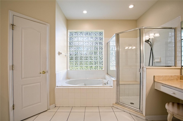 bathroom featuring independent shower and bath, vanity, and tile patterned floors