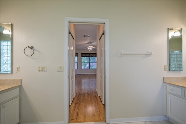 bathroom featuring vanity, hardwood / wood-style flooring, and ceiling fan