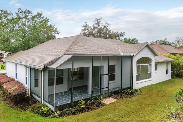 back of house featuring a sunroom and a yard