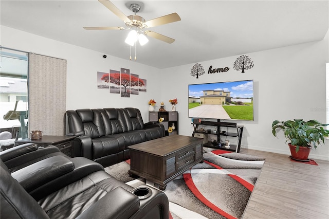 living room with ceiling fan and light hardwood / wood-style floors