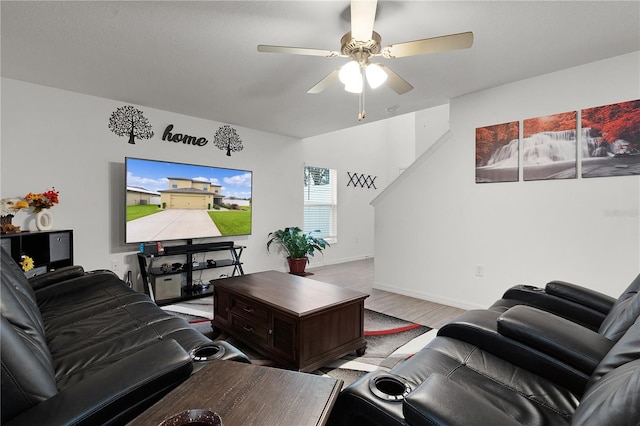 living room with ceiling fan and light hardwood / wood-style floors