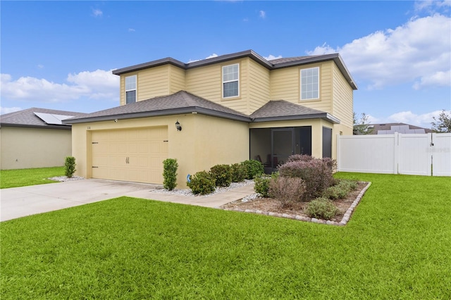 view of front of home featuring a front yard and a garage