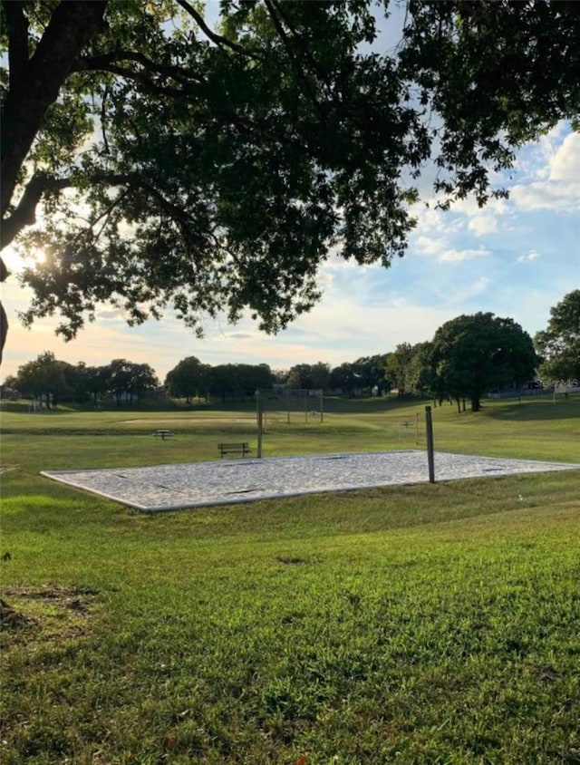 view of home's community featuring a yard and volleyball court