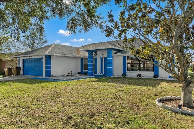 view of front of property featuring a garage and a front lawn