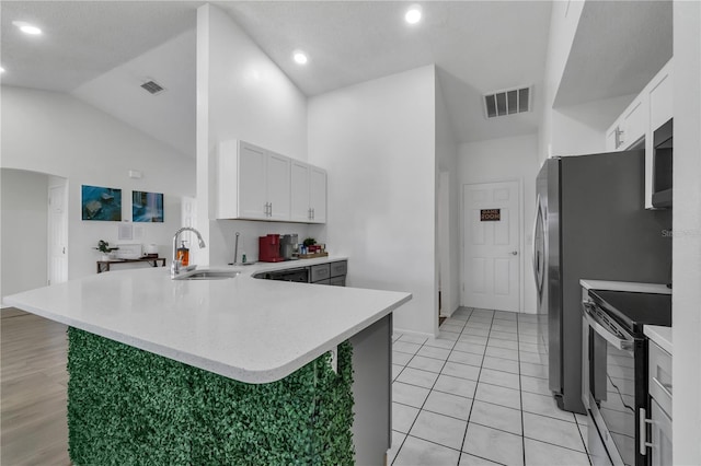 kitchen featuring white cabinets, sink, stainless steel electric range oven, kitchen peninsula, and high vaulted ceiling