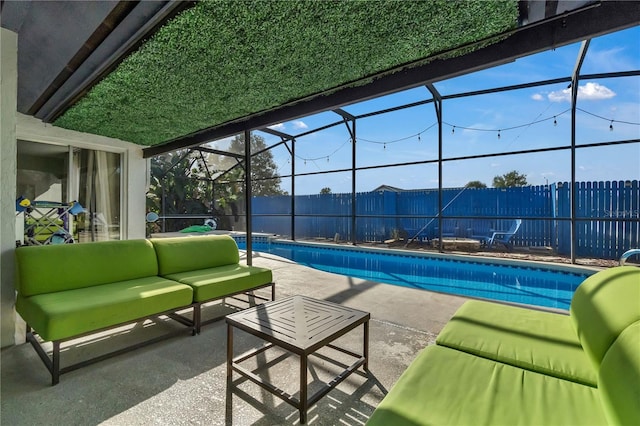 view of pool with an outdoor living space, glass enclosure, and a patio area