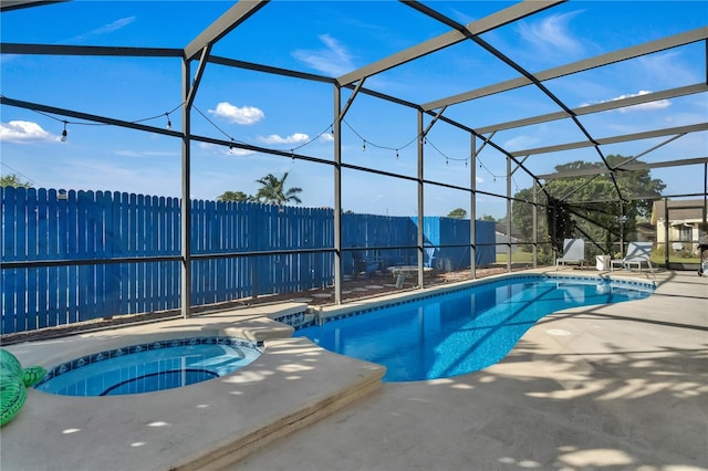 view of swimming pool featuring an in ground hot tub, a lanai, and a patio area