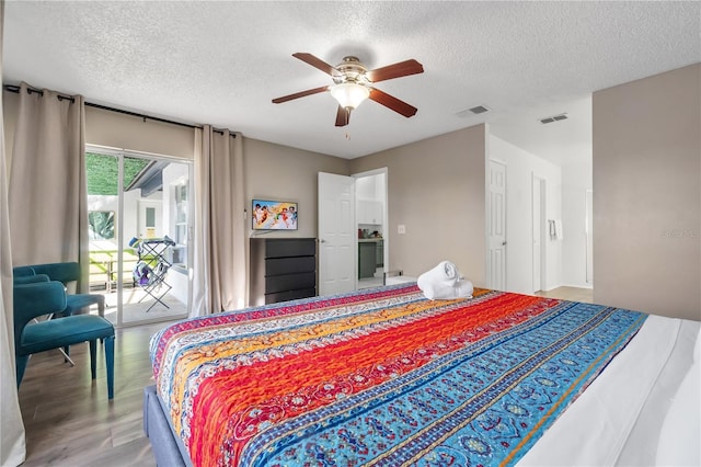 bedroom with hardwood / wood-style flooring, a textured ceiling, ceiling fan, and access to outside