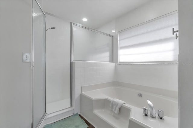 bathroom with separate shower and tub and tile walls