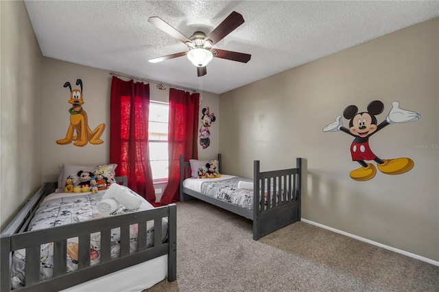 carpeted bedroom featuring a textured ceiling and ceiling fan