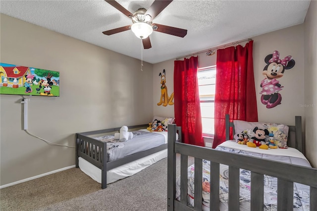 carpeted bedroom with ceiling fan and a textured ceiling