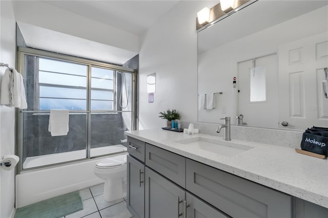 full bathroom with toilet, tile patterned flooring, enclosed tub / shower combo, and vanity