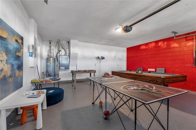 recreation room with gas water heater and a textured ceiling