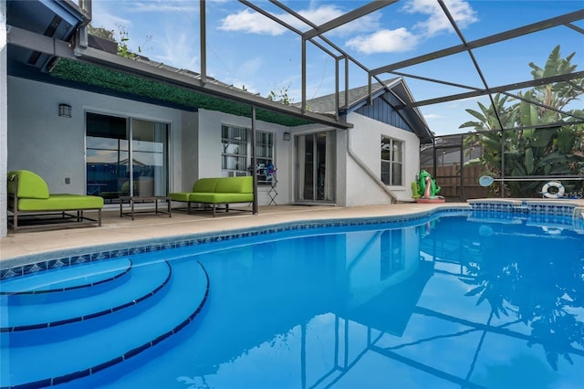 view of swimming pool featuring glass enclosure and a patio area