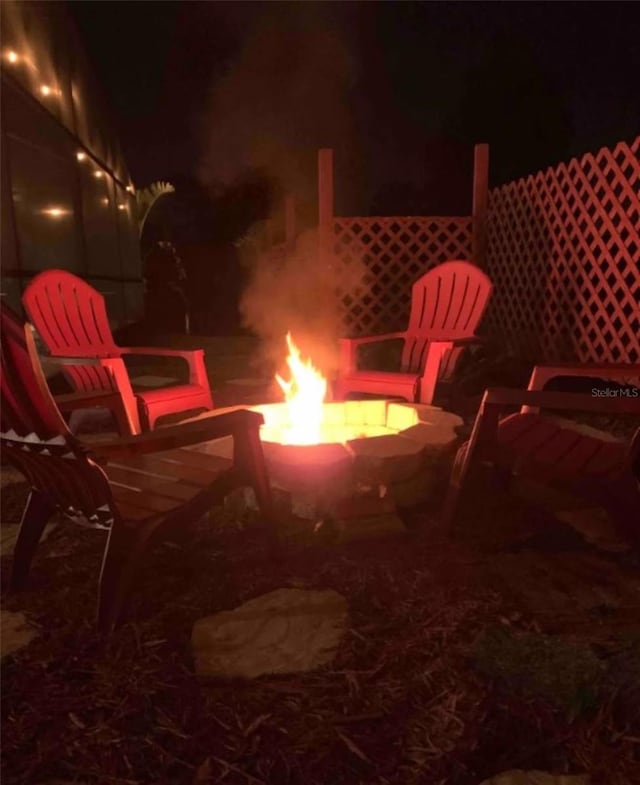 patio at night featuring an outdoor fire pit