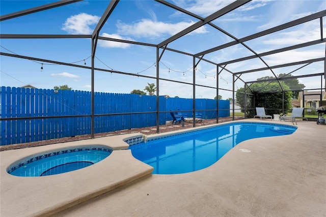 view of pool with an in ground hot tub, a lanai, and a patio