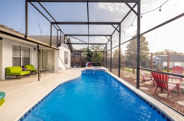 view of pool featuring a lanai and a patio