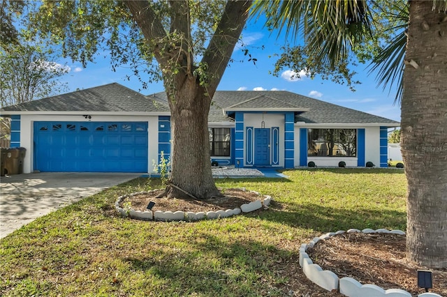 view of front of home with a garage and a front lawn