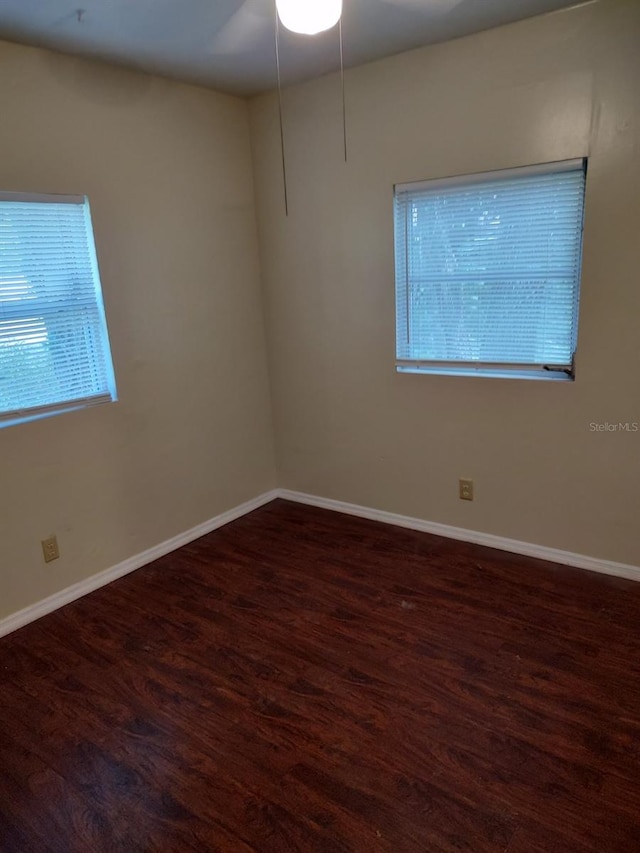 unfurnished room with dark hardwood / wood-style floors