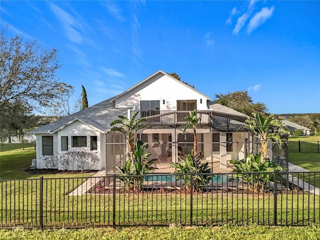 back of property featuring a lanai, a balcony, a lawn, and a patio