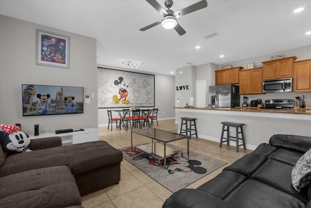 living room with ceiling fan, light tile patterned flooring, recessed lighting, visible vents, and baseboards