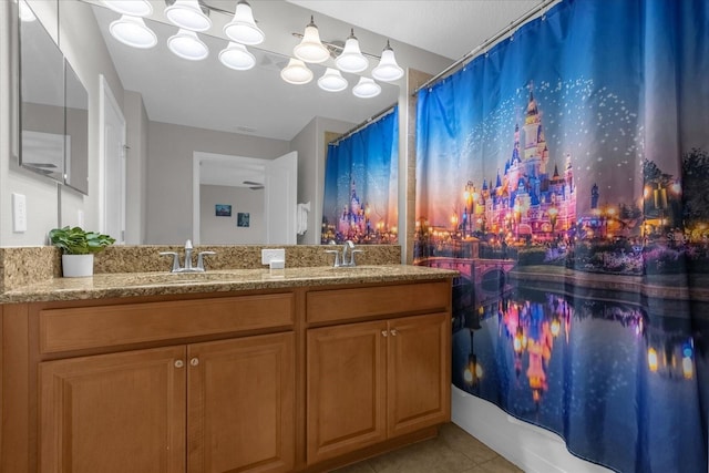 bathroom featuring double vanity, shower / bathtub combination with curtain, a sink, and tile patterned floors