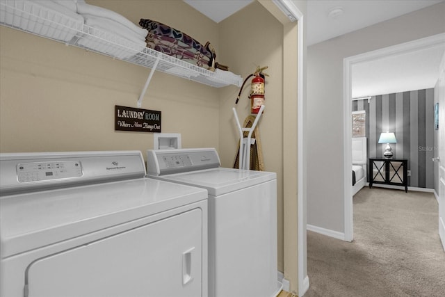 washroom featuring laundry area, light carpet, independent washer and dryer, and baseboards