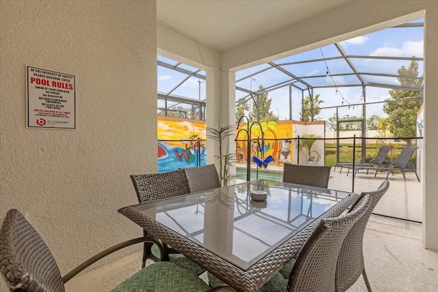 view of patio / terrace with glass enclosure and outdoor dining area