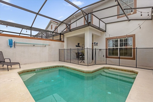 view of swimming pool featuring a patio area and glass enclosure