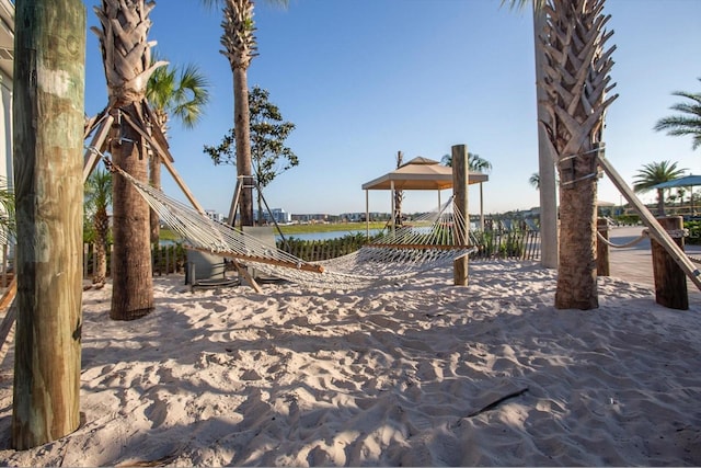 view of playground with a water view and a gazebo