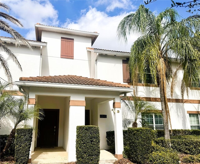 view of front of house featuring a tile roof and stucco siding