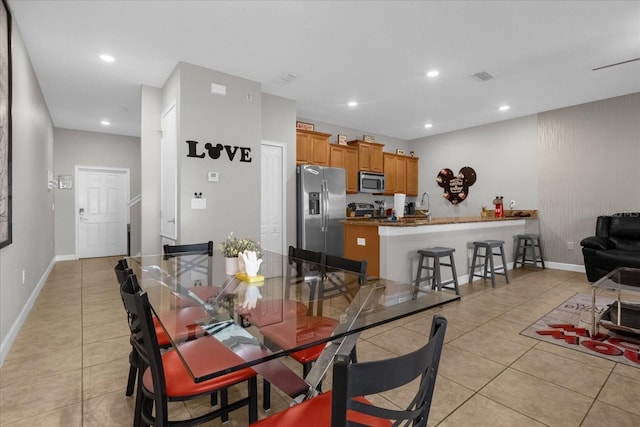 dining room with light tile patterned floors, visible vents, and recessed lighting