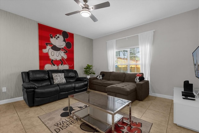 living room with light tile patterned floors, ceiling fan, an accent wall, and baseboards