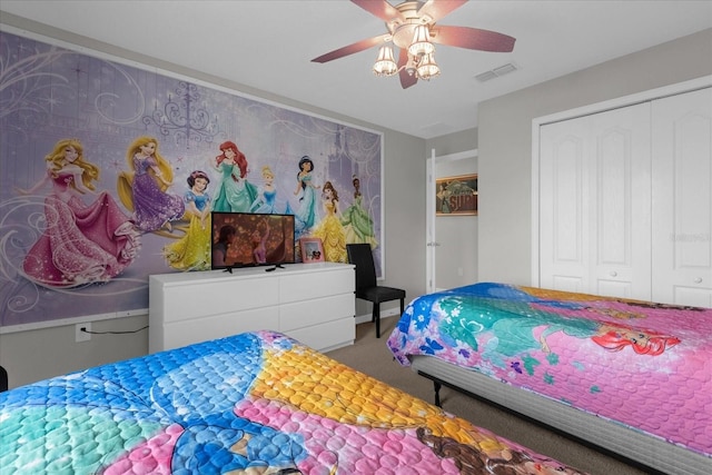 carpeted bedroom with a ceiling fan, a closet, and visible vents