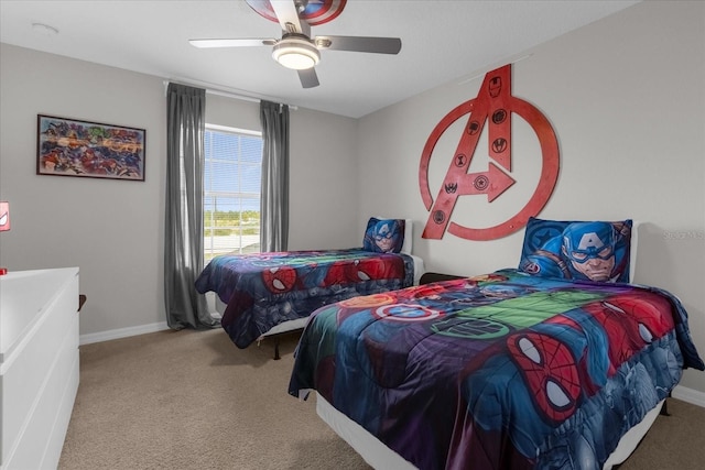 carpeted bedroom with a ceiling fan and baseboards