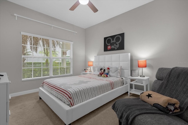 bedroom with light carpet, a ceiling fan, and baseboards