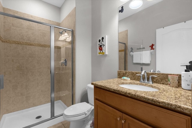 full bathroom featuring toilet, a stall shower, and vanity