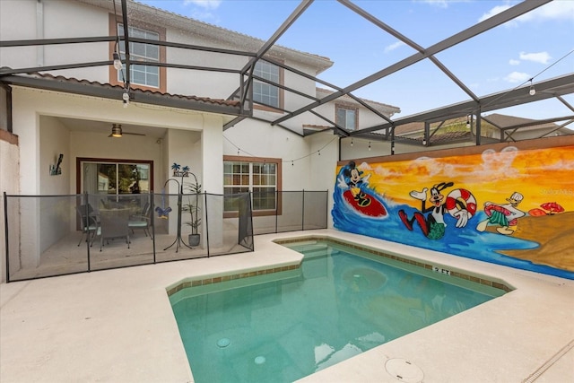 view of swimming pool featuring glass enclosure and a patio