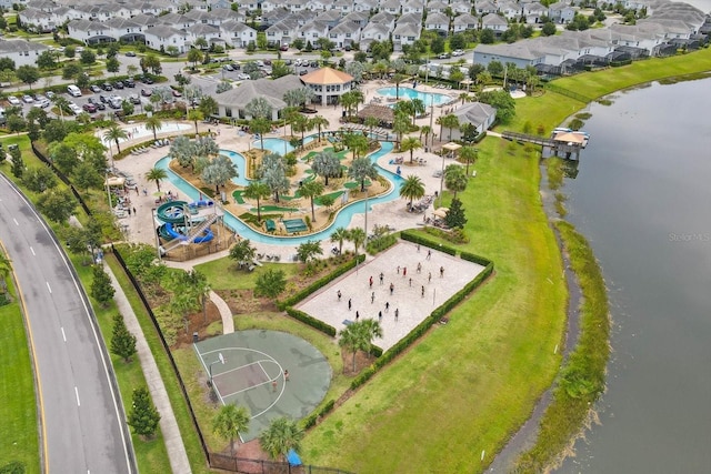 drone / aerial view featuring a residential view and a water view