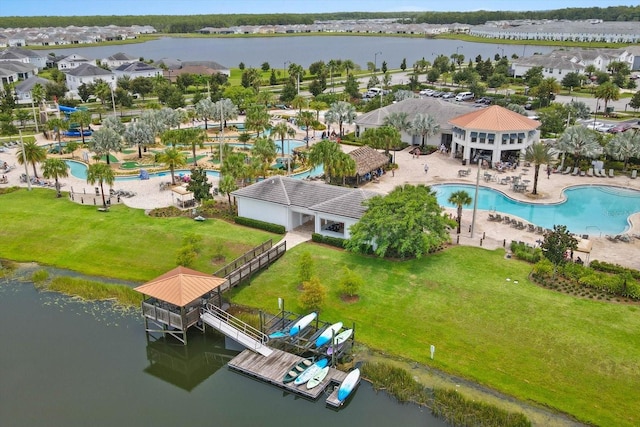 drone / aerial view with a residential view and a water view