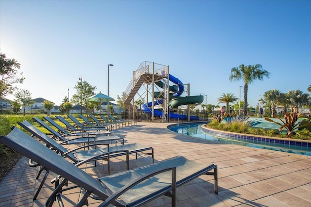 view of community with a patio area, fence, and a swimming pool