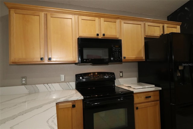 kitchen with light brown cabinets and black appliances