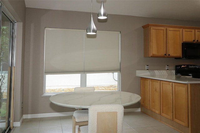 dining space featuring light tile patterned flooring