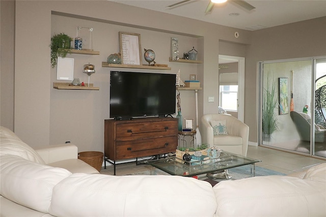 living room with ceiling fan and light tile patterned floors