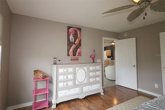 bedroom with ceiling fan and dark hardwood / wood-style flooring