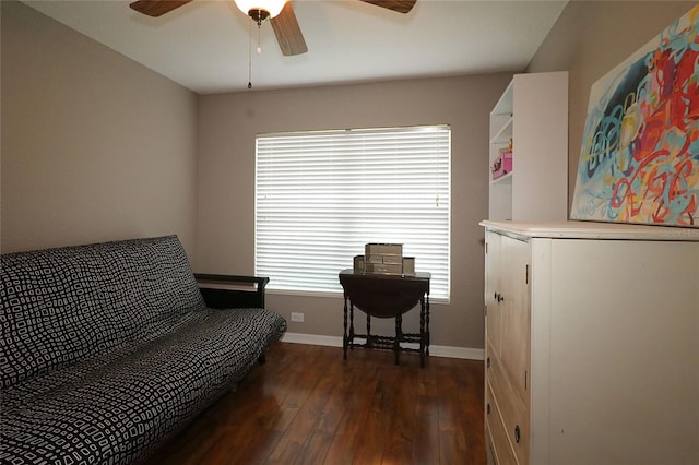 living area with ceiling fan and dark wood-type flooring