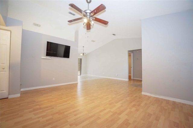 unfurnished living room featuring ceiling fan with notable chandelier, light wood-type flooring, and vaulted ceiling